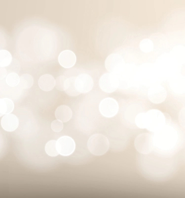 White circles of light sparkle against a beige background in the mobile banner.