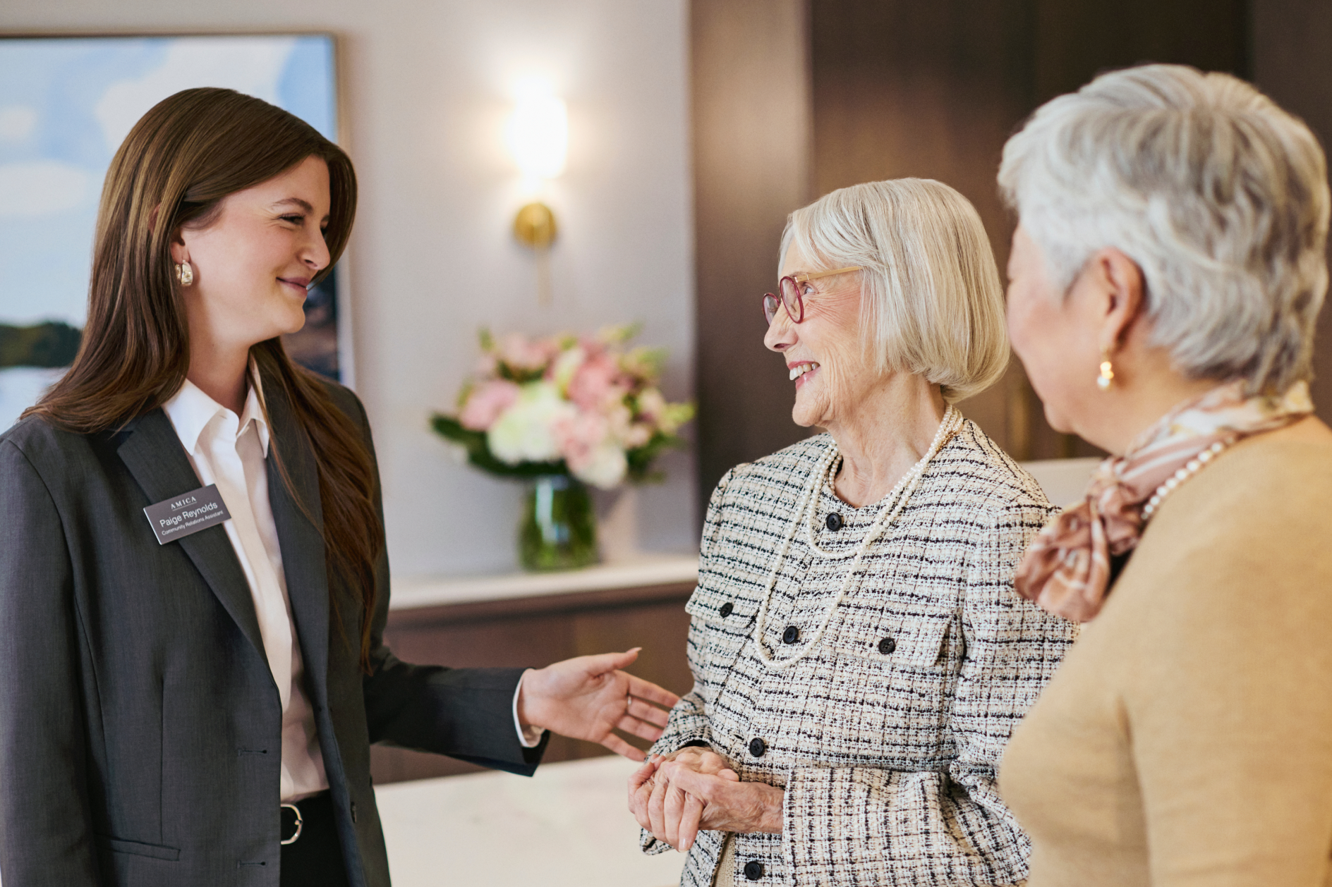 An Amica representative speaking with two senior ladies.
