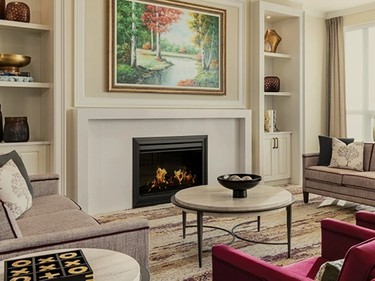 Lounge with fireplace and bright, neutral tones.