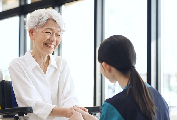 KER-AL-suites-additional-care-asian-woman-with-caretaker An elegant senior Asian woman smiling at her caregiver