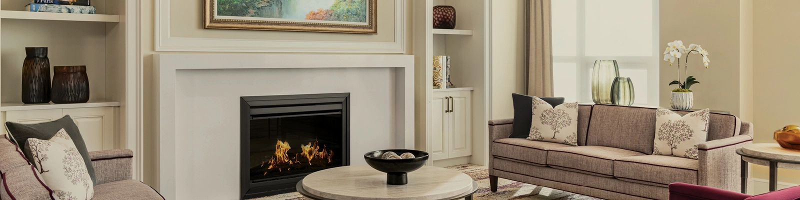 Lounge with fireplace and bright, neutral tones.