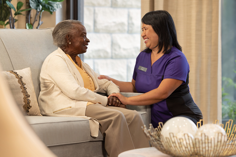 Stock image of Senior Asian woman on the bed with her caretaker