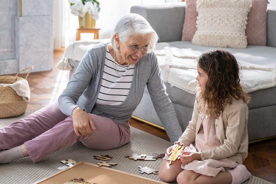 A shot of a senior making a jigsaw puzzle with a child