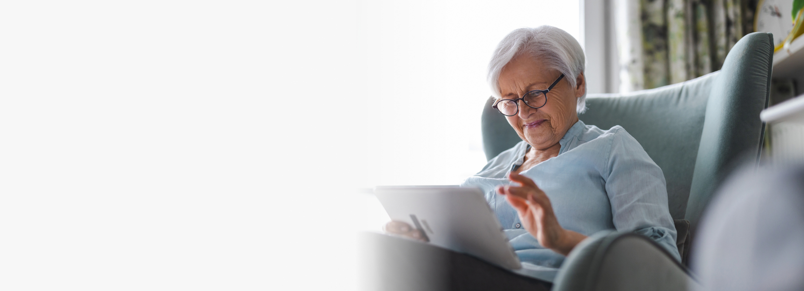 Senior woman looking at her ipad - Right Panel Senior woman looking at her ipad - Right Panel