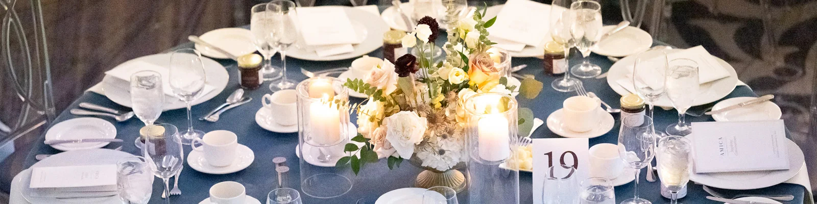 A full table setting, complete with lit candles, from the Amica Helping Hands Conversations Gala.