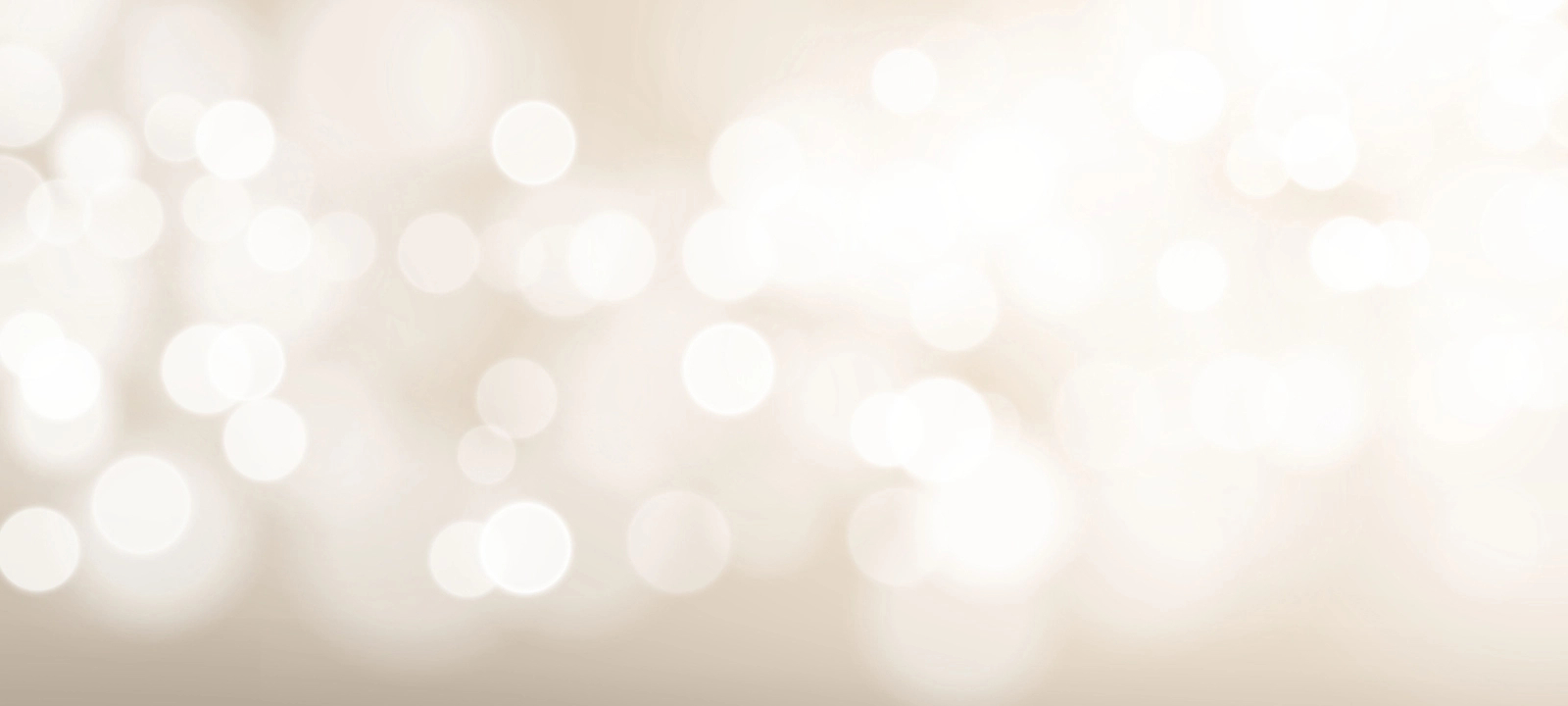 White circles of light sparkle against a beige background in the desktop banner.