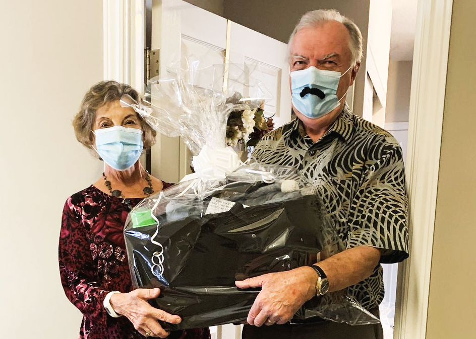 Residents from Amica Stoney Creek fill baskets with non-perishable foods, a warm blanket, gift certificates for local grocery stores and pharmacies, and hand-knit items.