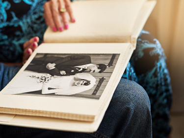 Senior couple looking through their wedding photo album.
