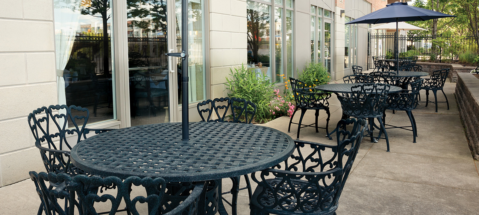 A patio at Erin Mills includes tables and umbrellas for enjoying the outdoors.