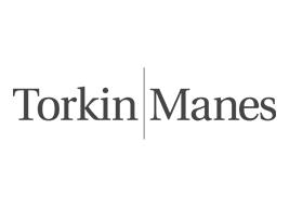 The Torkin Manes logo, which is 'Torkin' in black font separated by a line and followed by 'Manes.'