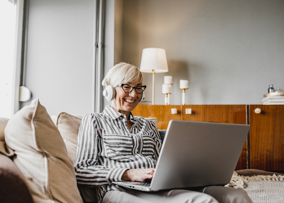 Senior woman is in her home using a laptop