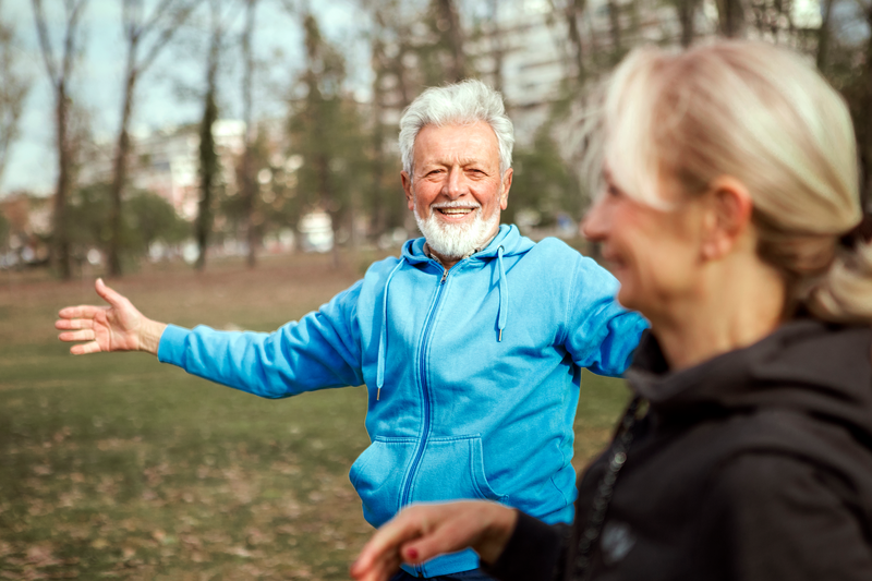 Senior Couple Exercising In Park