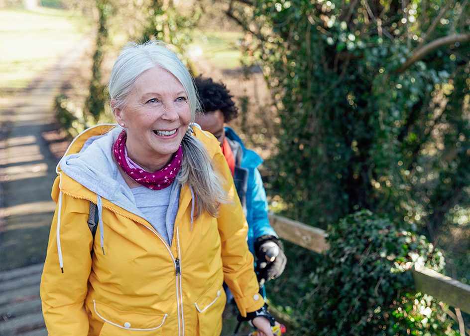 A senior woman going for a hike in the forest with her friends.