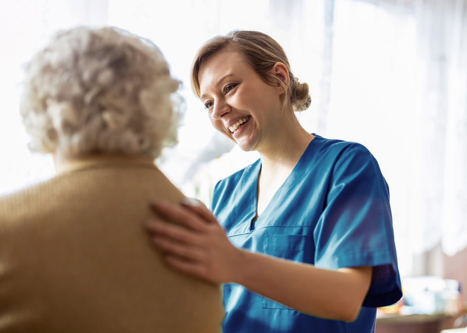 A friendly personal support worker helping an senior woman