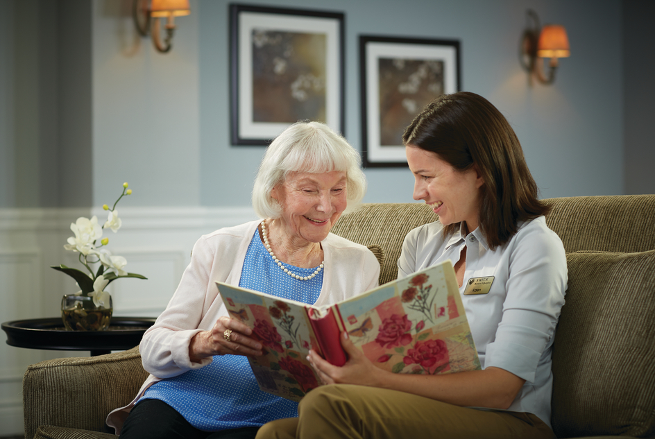 Image for Conversations Article Moving a loved one with dementia. Senior looking at photo album.
