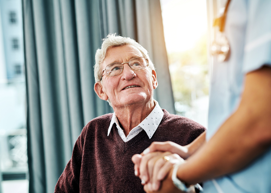 Cropped shot of a male nurse holding hands with a senior patient