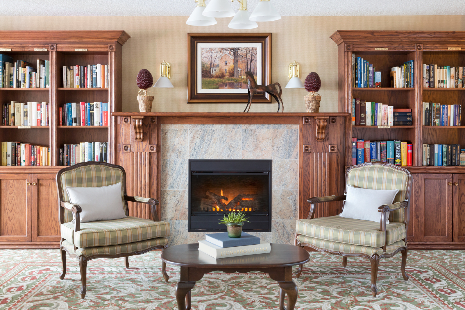 Library room with fireplace at Amica City Center senior living residence.