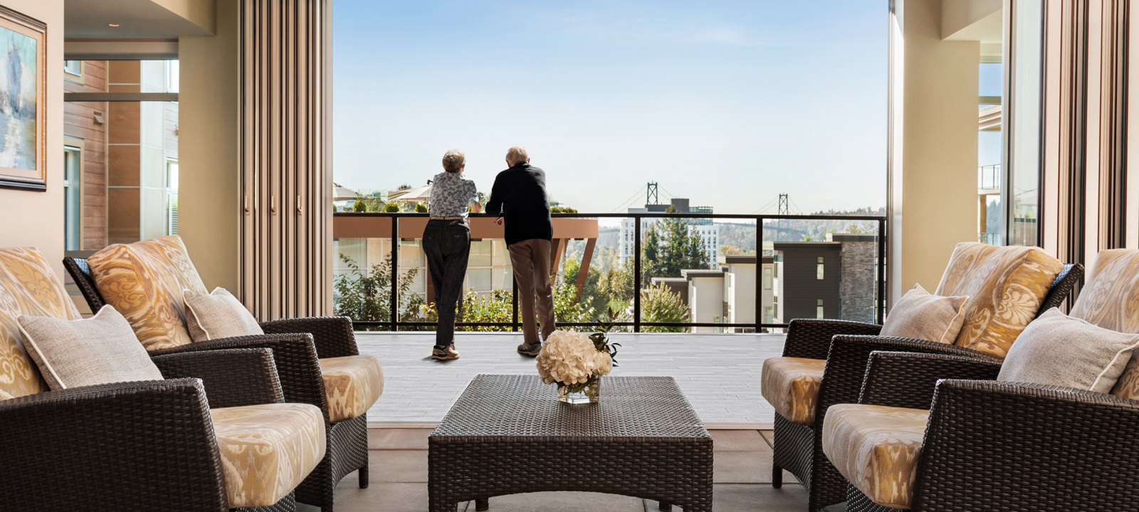 Shot of a senior couple in the balcony of Amica Lions Gate enjoying the view.