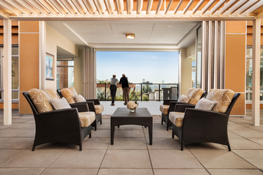 Shot of a senior couple in the balcony of Amica Lions Gate enjoying the view.