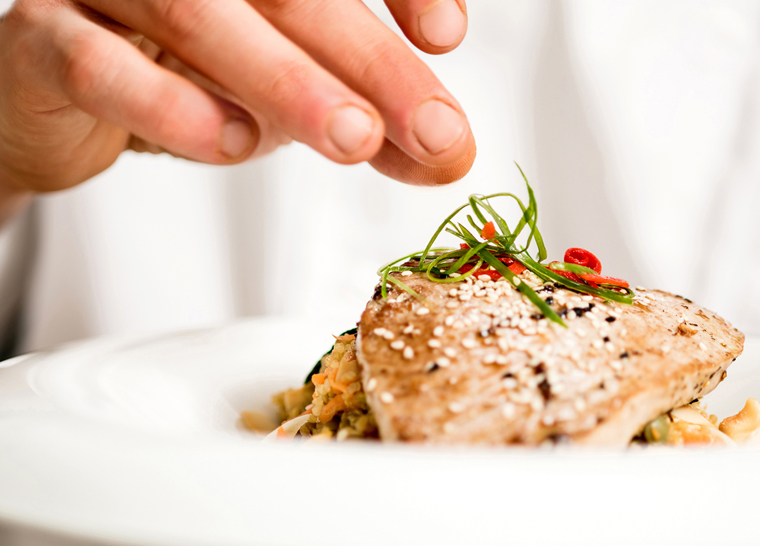 Chef preparing meal at Amica senior living residence.