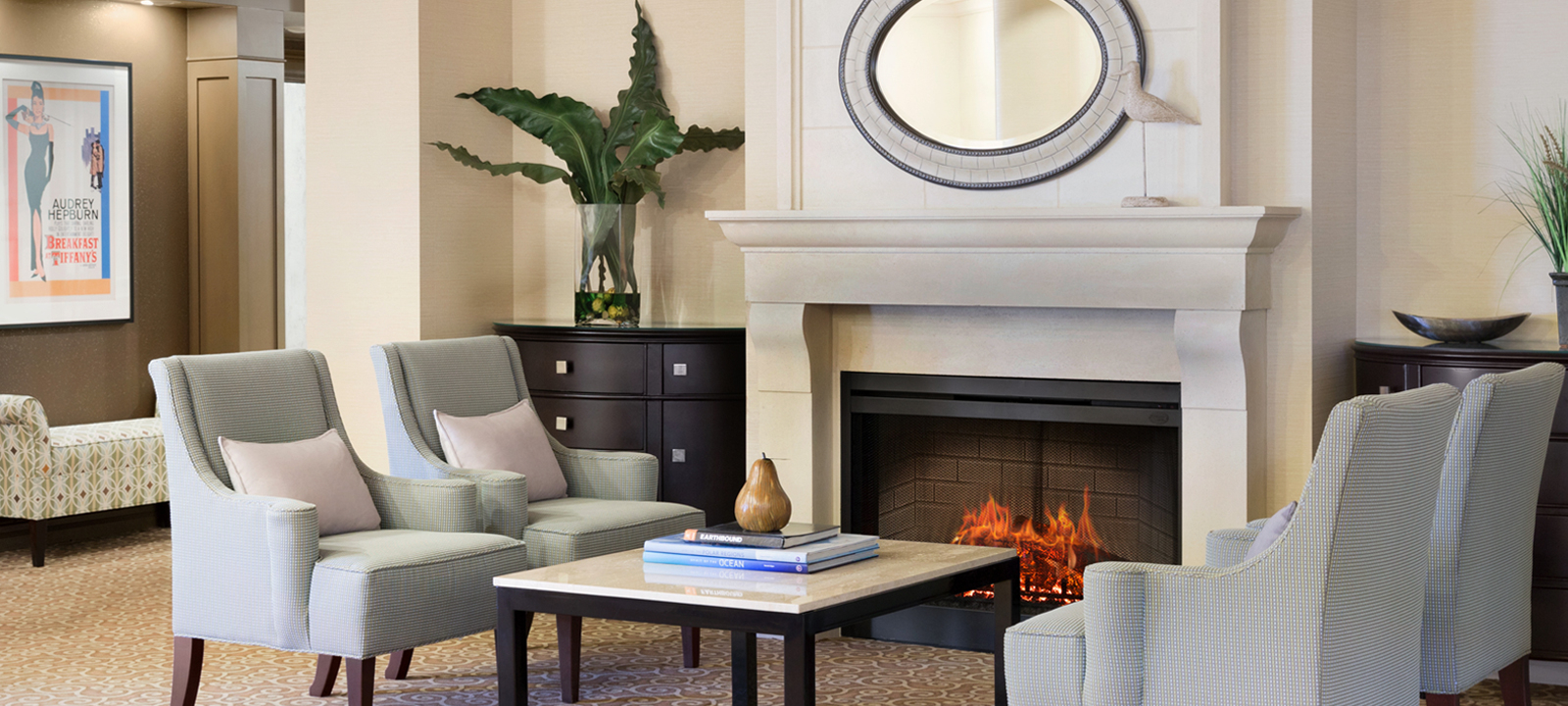 Amica Whitby senior living residence waiting area with fireplace and couches.